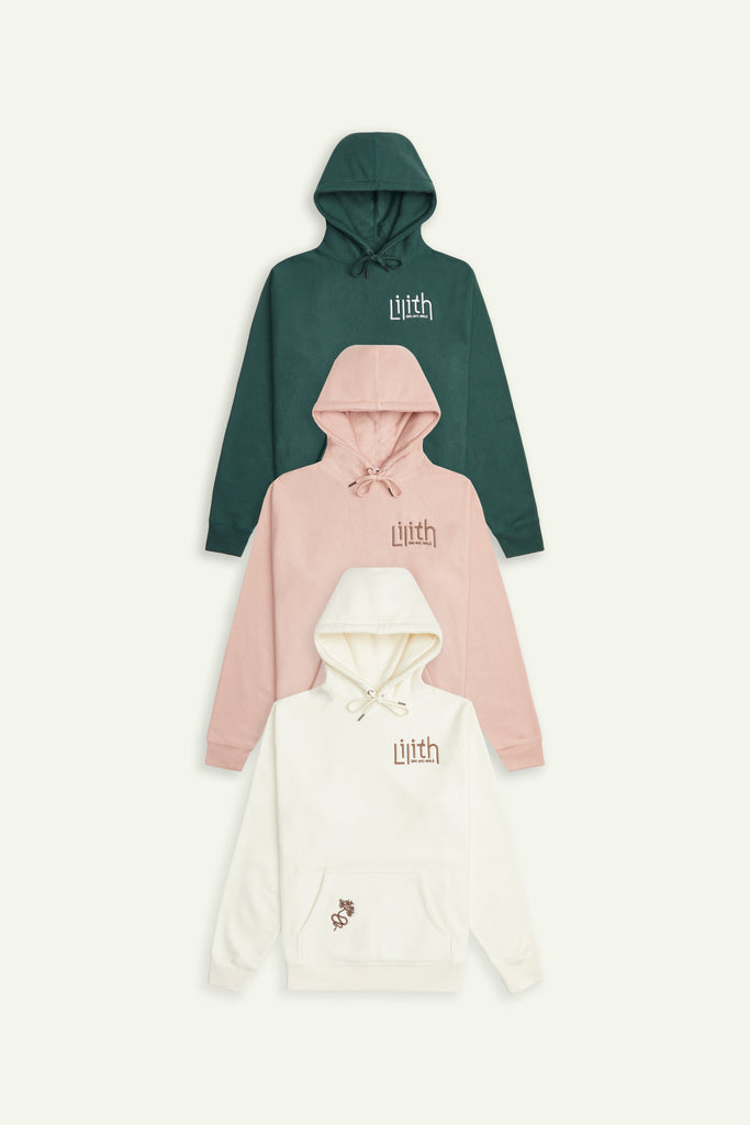 Jungle green, dusty pink, and cream-colored hoodies pictured stacked as a flat lay.