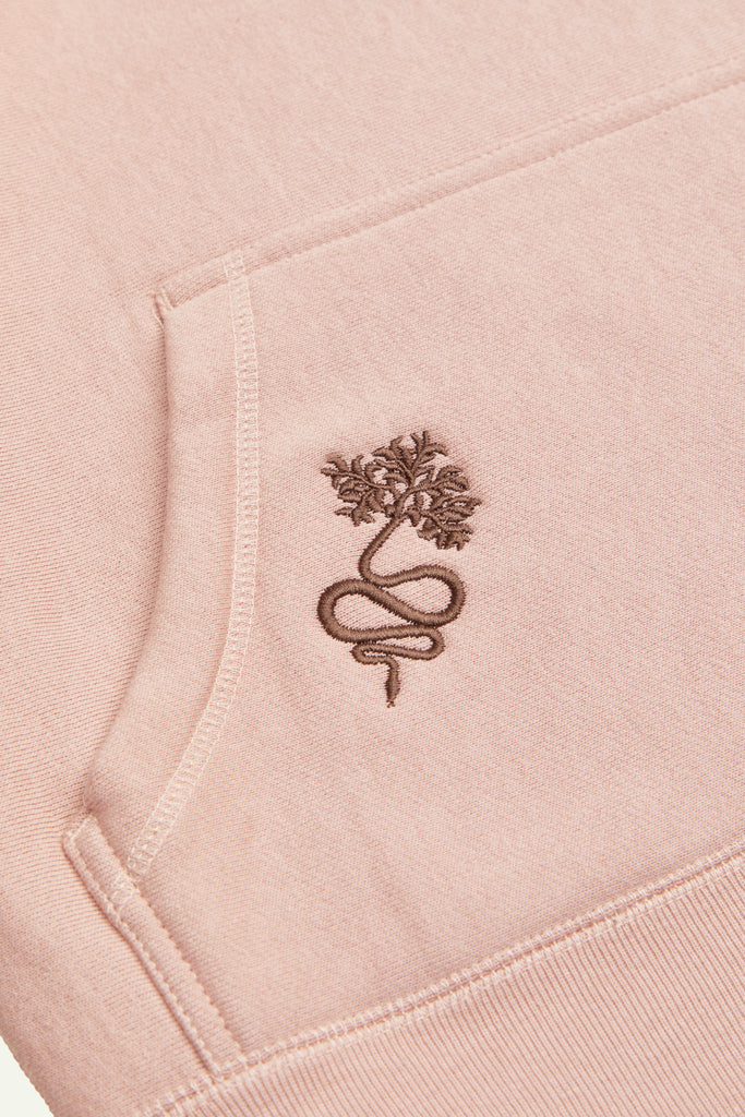A light or dusty pink hoodie with the Lilith NYC wordmark logo embroidered on the upper left chest area. Embroidery of a snake with a branch tail is located on the right side of the kangaroo pocket. All embroidery is in brown or dark chocolate.