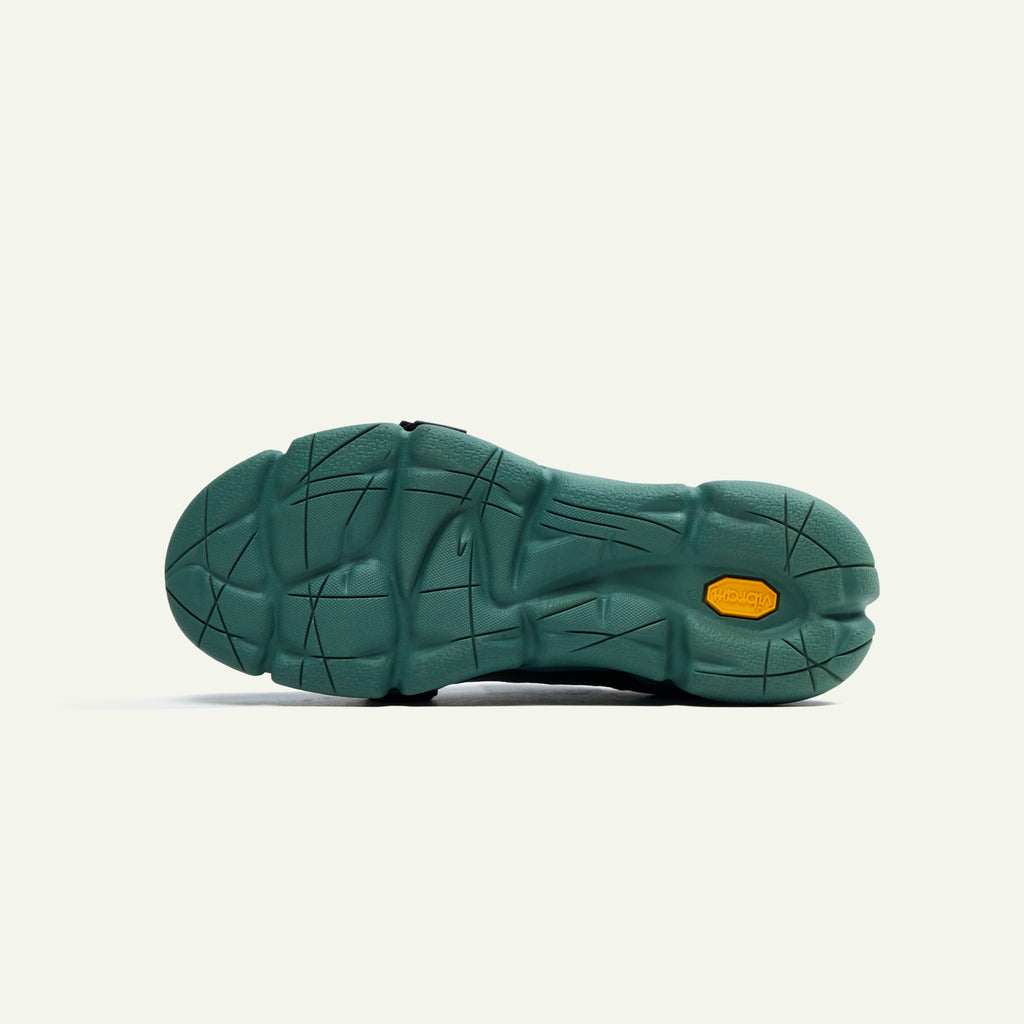 A bottom-view image of the Caudal Lure sneaker. The image is of the Vibram sole tooling called Plump in the Pantone color Duck Green.