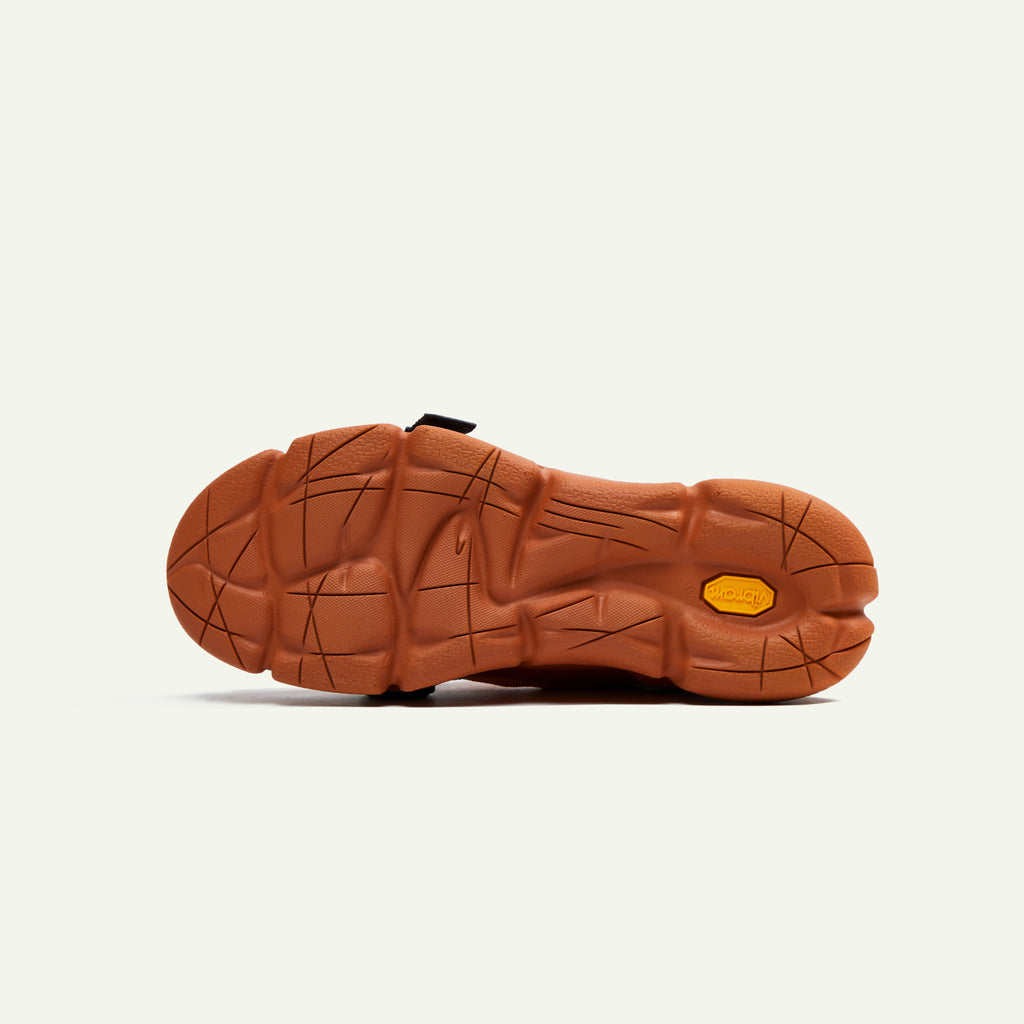 A bottom-view image of the Caudal Lure sneaker. The image is of the Vibram sole tooling called Plump in the Pantone color Umber.