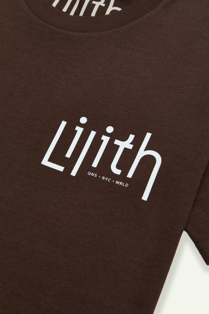A dark brown or dark chocolate colored crewneck t-shirt with the Lilith NYC wordmark screen printed on the upper left chest area. The logo is white.